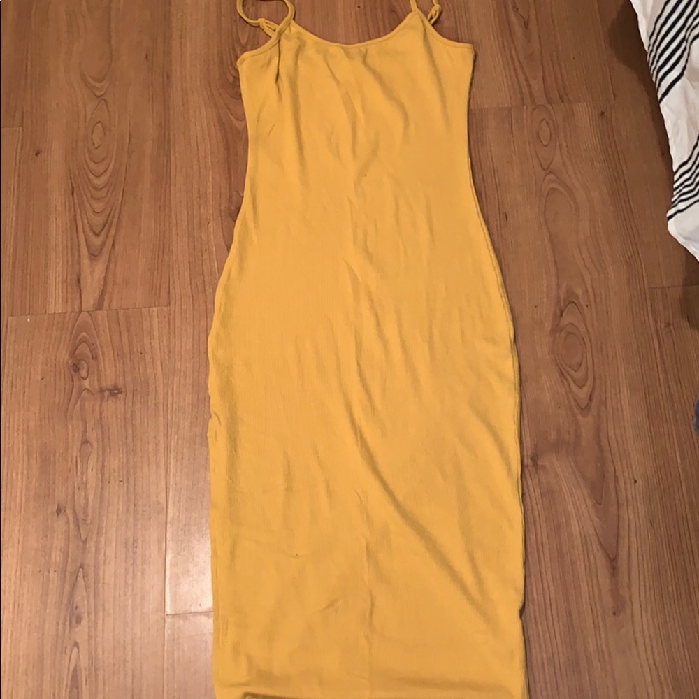 yellow fashion nova dress with slit on the leg